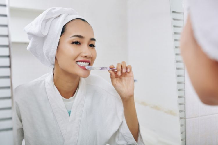 woman brushing teeth for bedtime routine