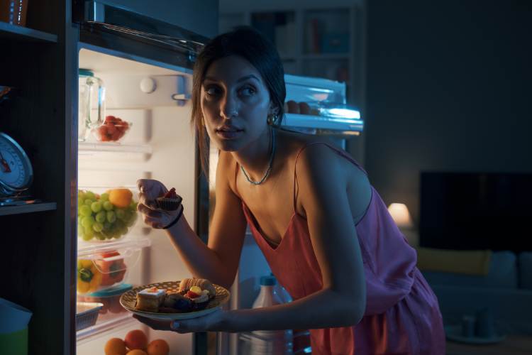 woman eating at night