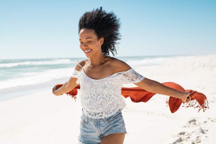 woman soaking up sunlight on the beach