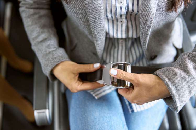 woman buckling seat belt