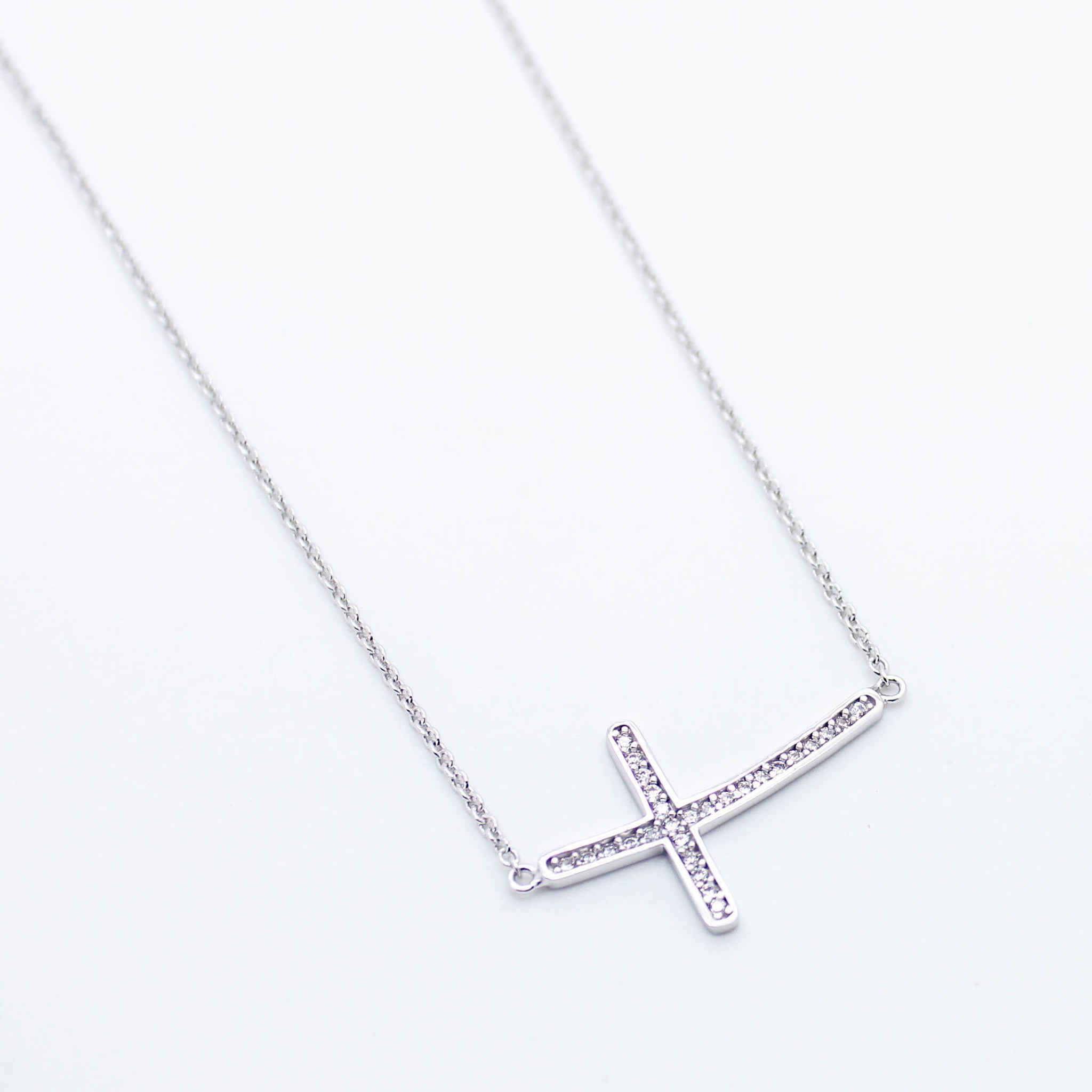 Curved cross sterling silver necklace