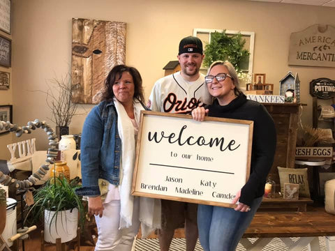 CEO, Alicia Gardner, with 2 happy customers picking up their custom order sign!
