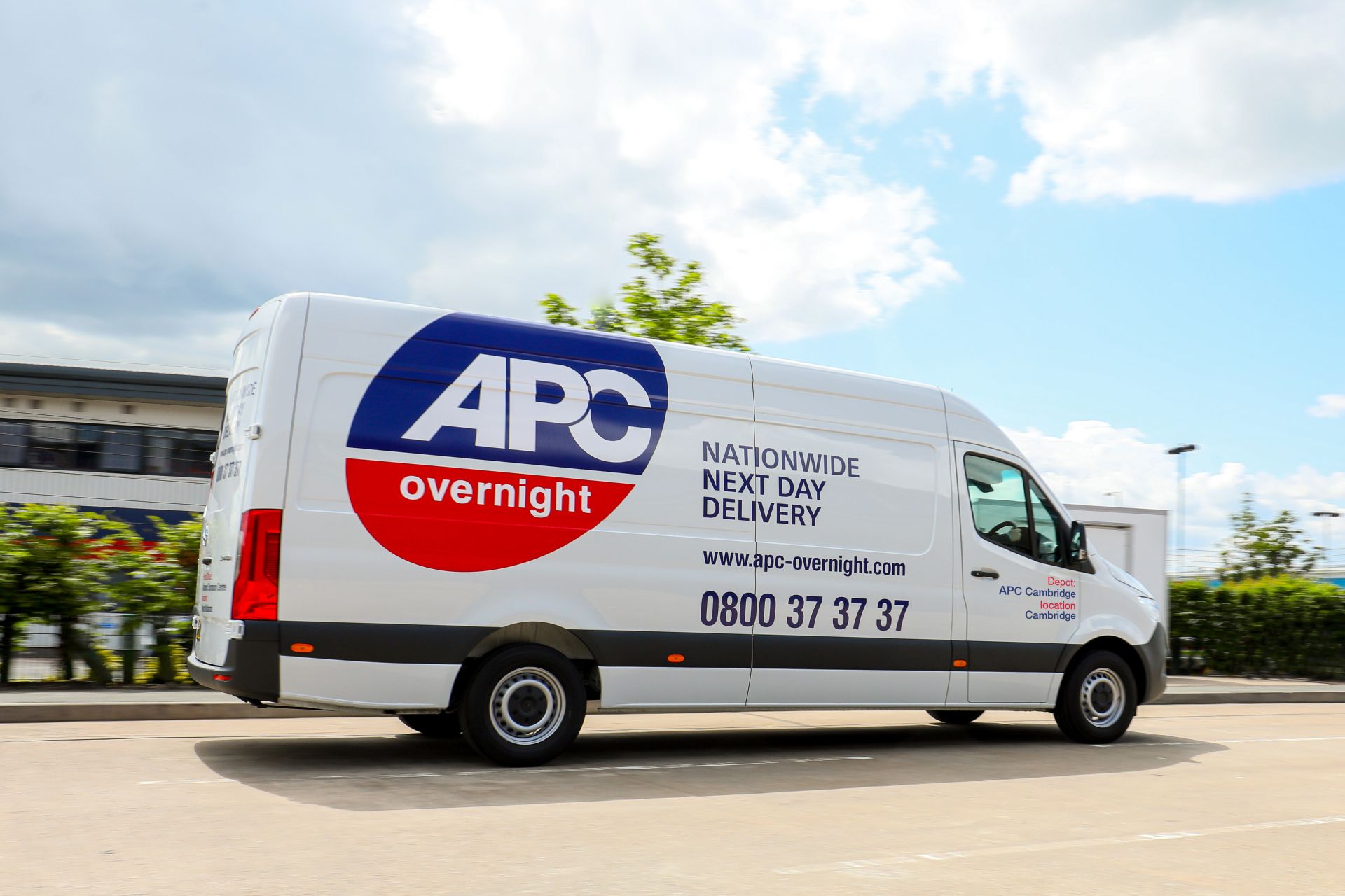 APC Overnight delivery van travelling on the road.