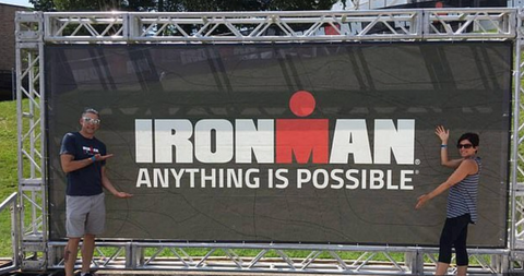 Athletes in front of Ironman sign