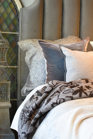 Linen jacquards, velvet and cashmere in a melodious melange resting on and ivory woven cashmere bedcover from Biella Italy.