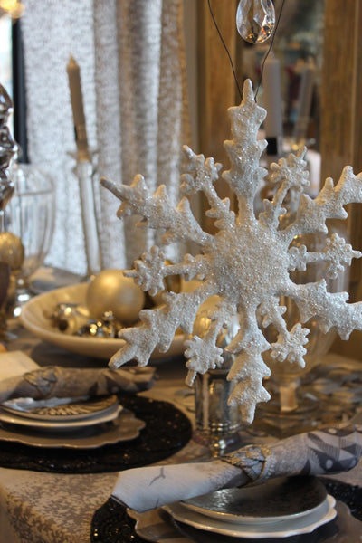 Snowflake ornament against festive holiday table setting