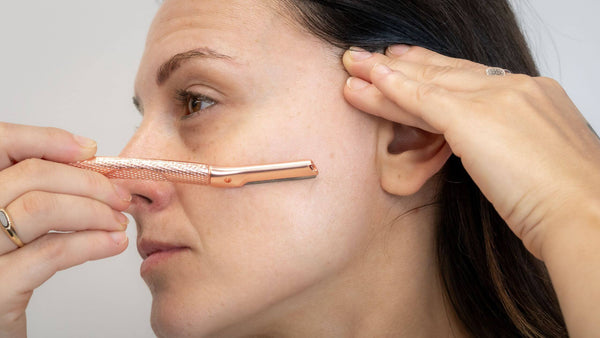 Woman uses the dermaplaning tool with a 45 degree angle and shaves with the hair growth