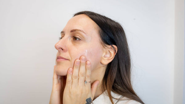 Woman cleans her face before using the dermaplaner