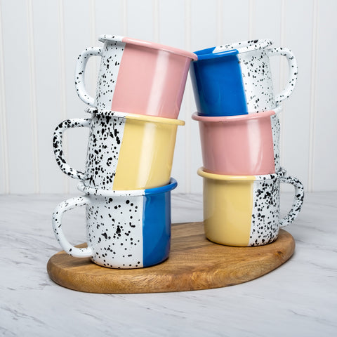 3 color enamel mugs on top of each other in blue pink yellow