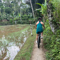 woman cycling through Ubud