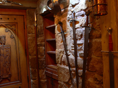 A guard room in domestic castle man cave upper hall sword fan.