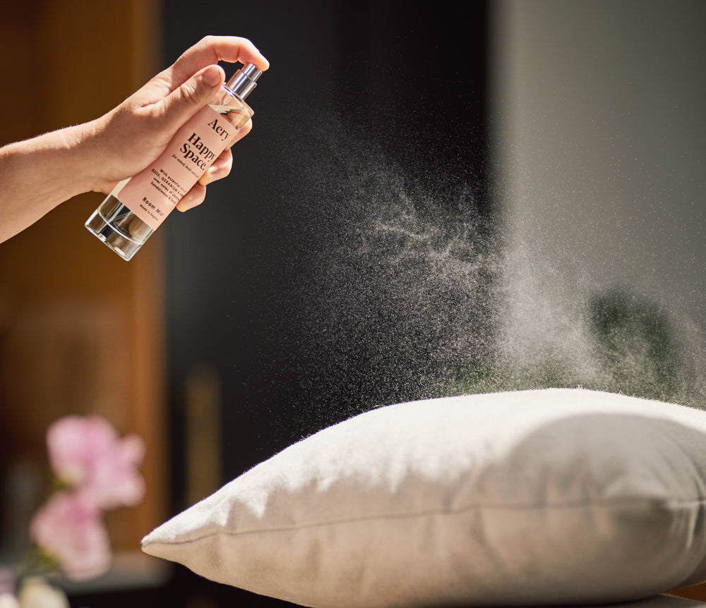 room mist being sprayed on pillows and linens