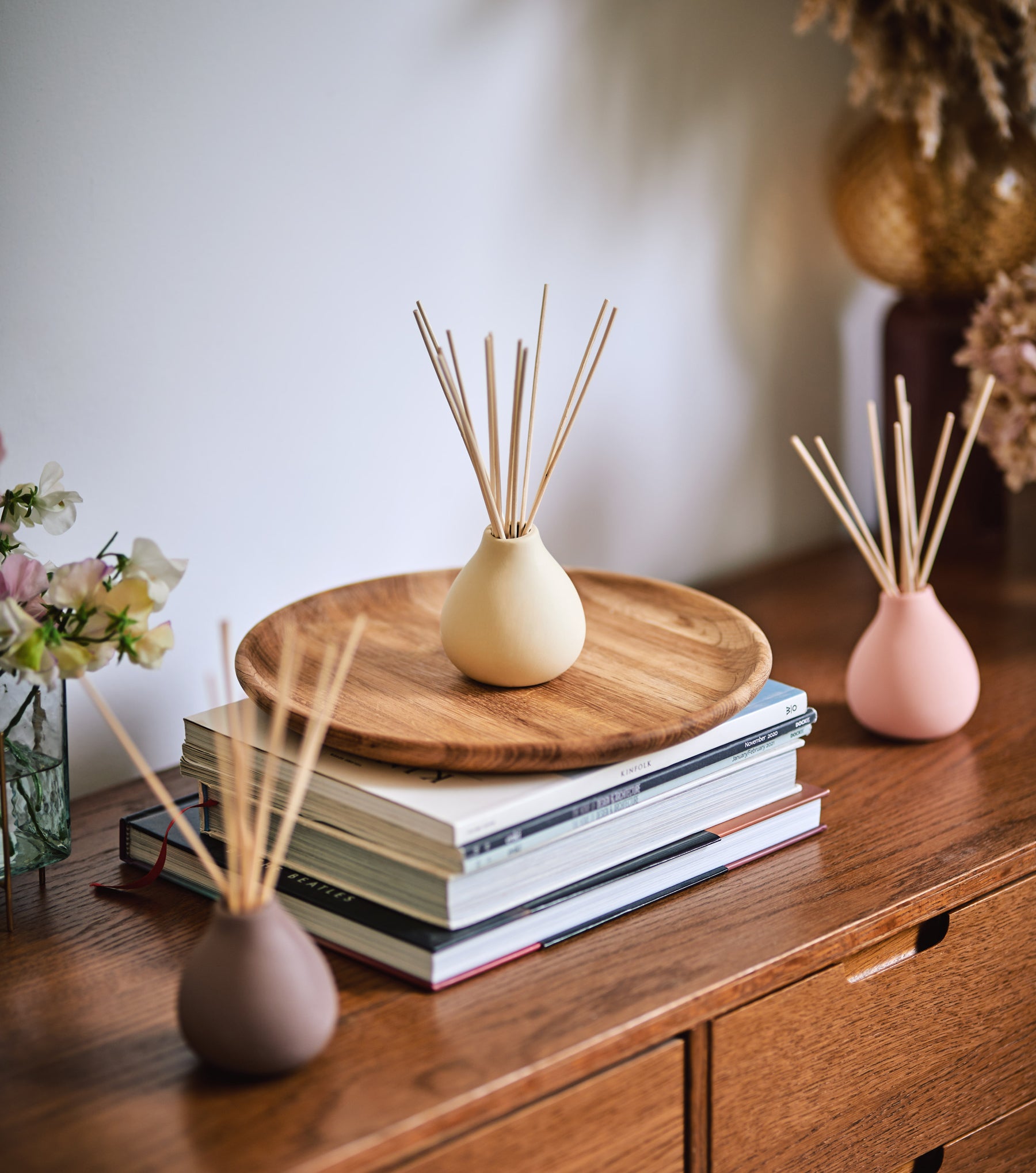sideboard setting with decorative coloured clay pot reed diffusers