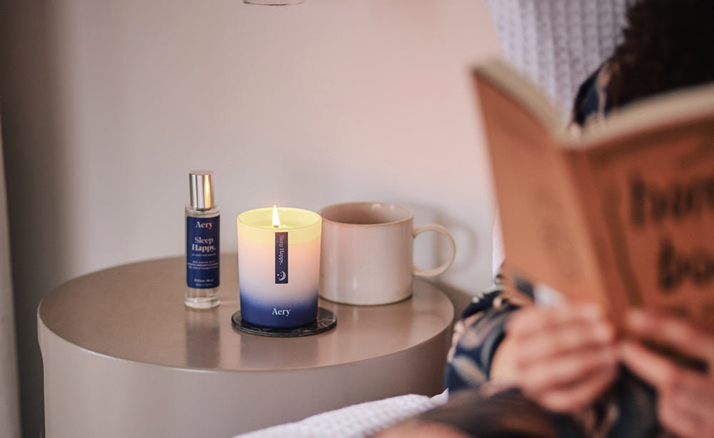 bedside table setting with person reading in bed