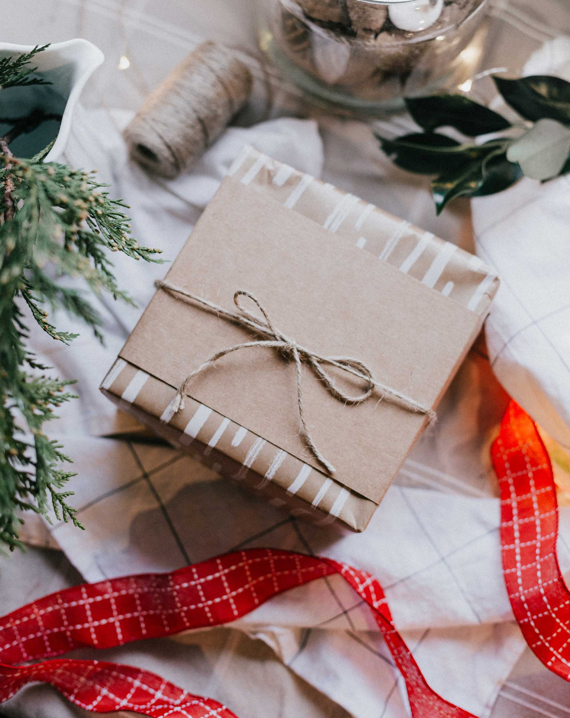 sustainable christmas gift wrap featuring kraft paper, twine and re-usable ribbon