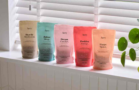 collection of aromatherapy bath salt refill pouches by aery living displayed on window cil in bathroom