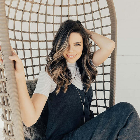 A woman modeling a curled hairstyle.