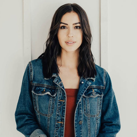 A brunette woman models a curled hairstyle. 