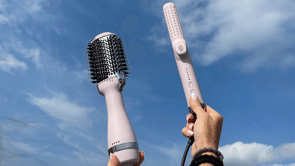 TYME blowbrush blow dryer brush and tyme iron air styling tool held up to the blue sky