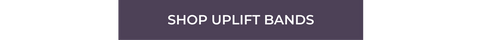 a dark purple button with white text that reads "shop uplift bands"