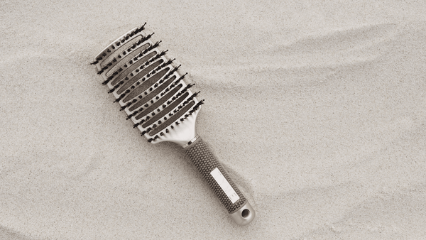 tyme detangling hair brush goes on a vacation to a sandy beach