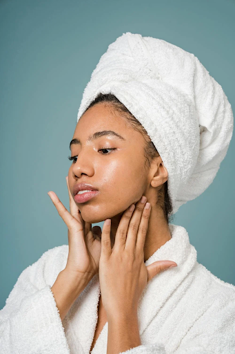 Image of a girl with a towel on her hair whilst it dries naturally.