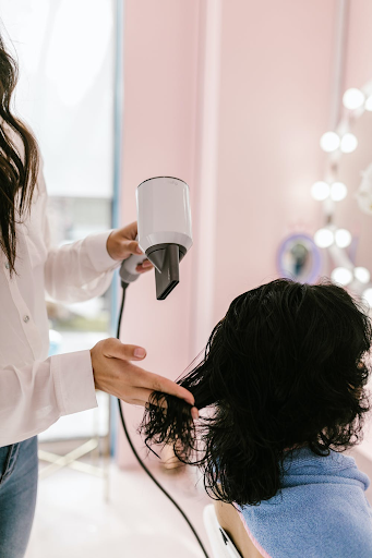 A woman with medium hair texture getting a blow dry.