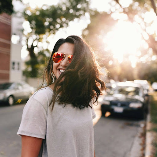 Woman with full, bouncy hair achieved with Velcro rollers. Credit: Matthew Hamilton, Unsplash