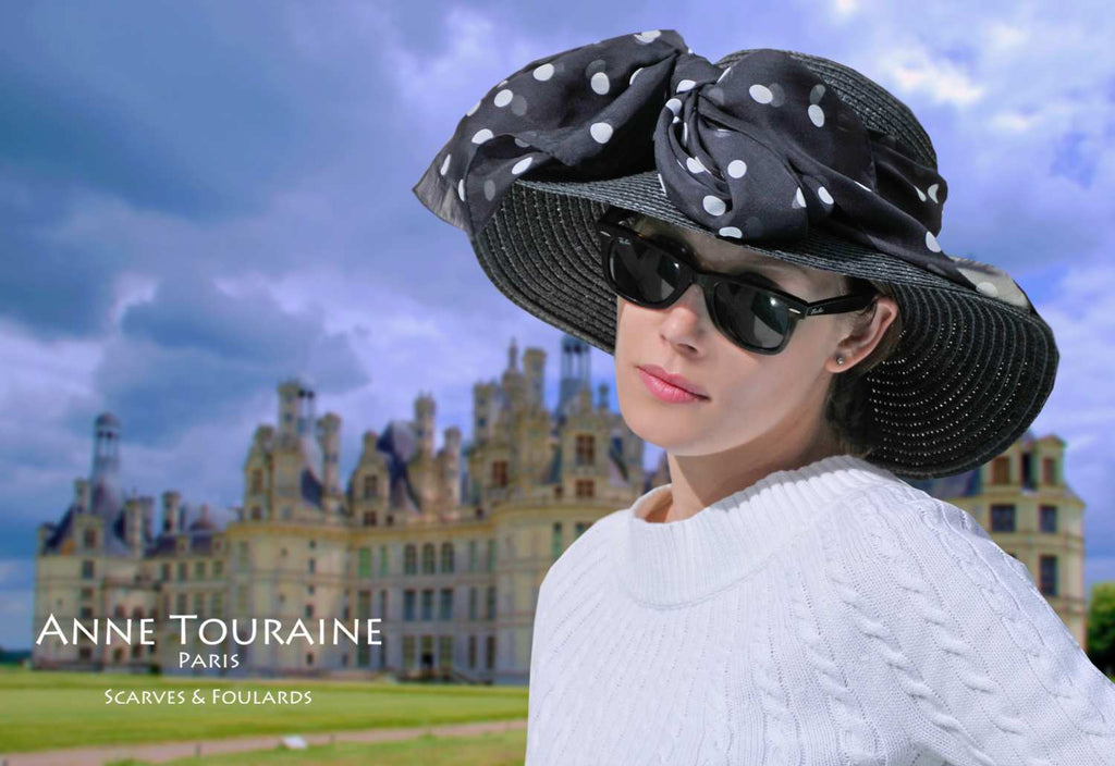 Chiffon silk scarves by ANNE TOURAINE Paris™: black polka dot scarf tied with a front fluffy bow around a straw hat