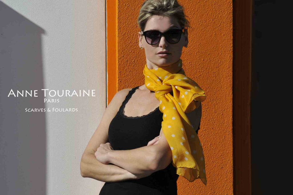 Chiffon silk scarves by ANNE TOURAINE Paris™: orange polka dot scarf wrapped twice around the neck and tied with a simple knot