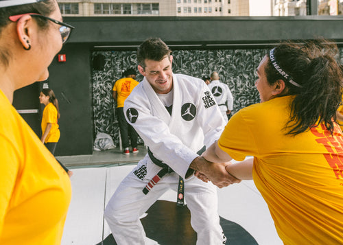 Instructor teaching woman self defense technique