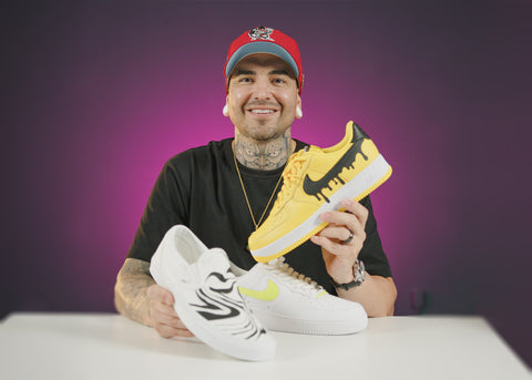 Jonothan Millar holding custom shoes in Cupixel studio