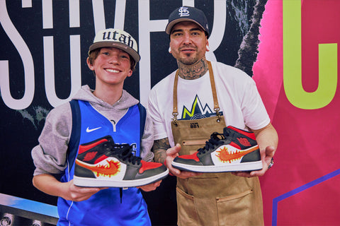 Jonathan Millar and guest showing off a a custom shoes made with Angelus Paints at the NBA Crossover