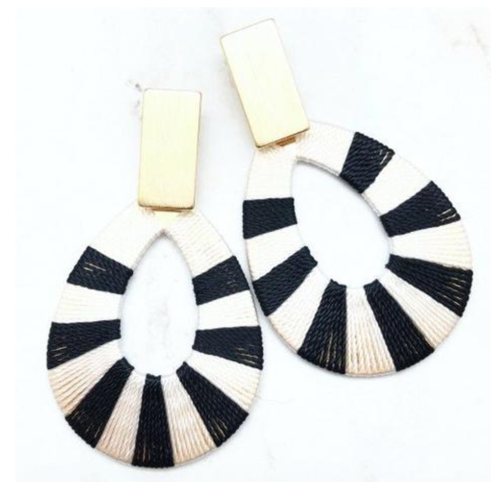 Fun <a href="https://huffharrington.com/collections/jewelry/products/shiver-and-duke-black-and-white-hoop-earrings" target="_blank">statement earrings</a> are easy to pack and you don’t have to panic if you lose them.