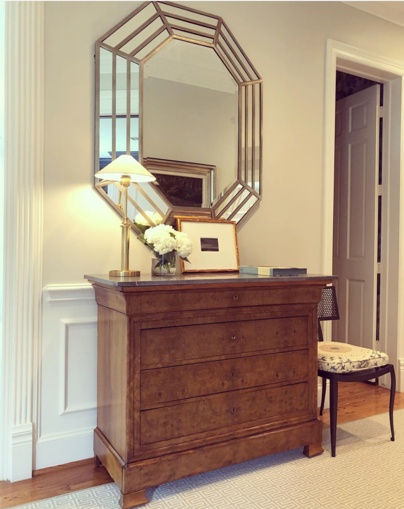 Here Paloma has created a graphic punch, marrying a pretty Louis Philippe walnut chest with an over sized octagonal mirror.