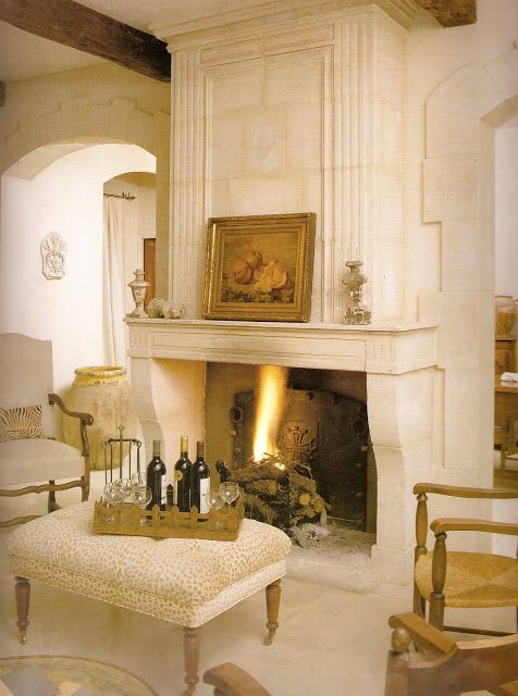 I wanted a pretty stone fireplace like this one, from Decor de provence.blogspot.de. (Note the 17th C. Biot jar in the background!)