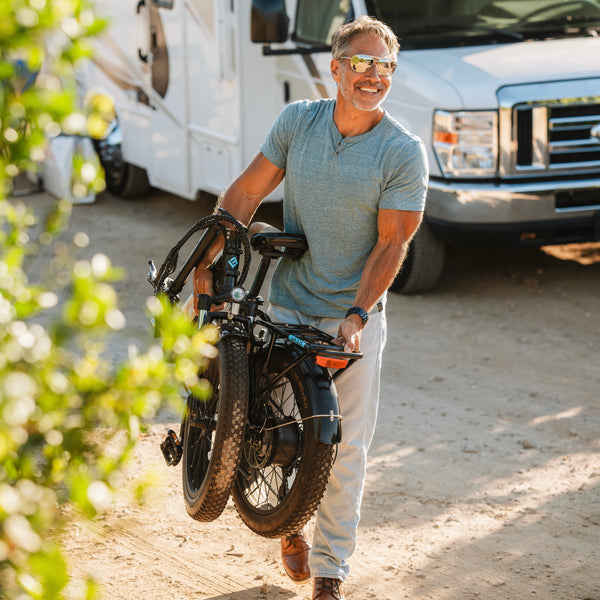 man carrying folded eBike