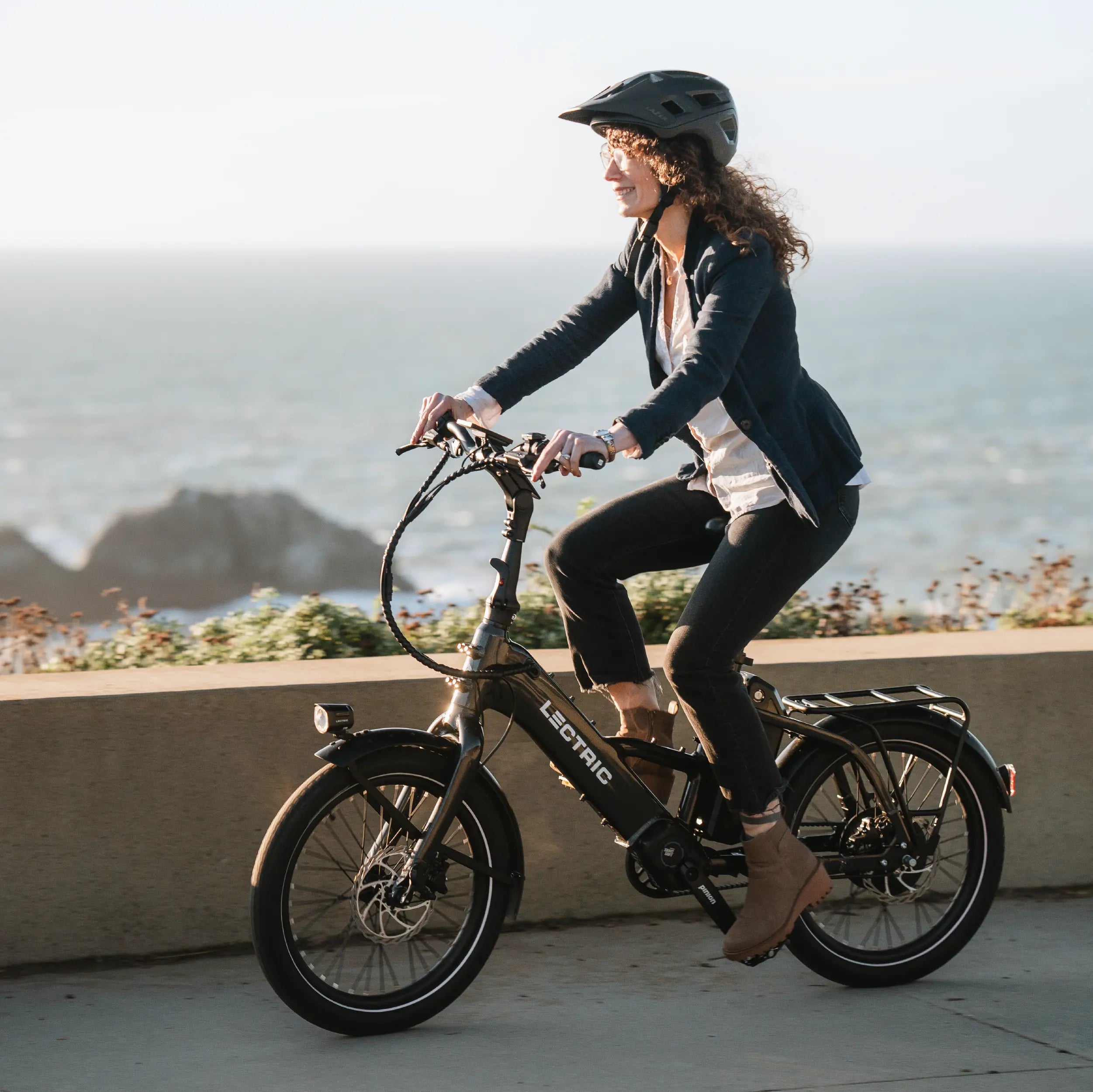 woman riding Lectric ONE along coastline