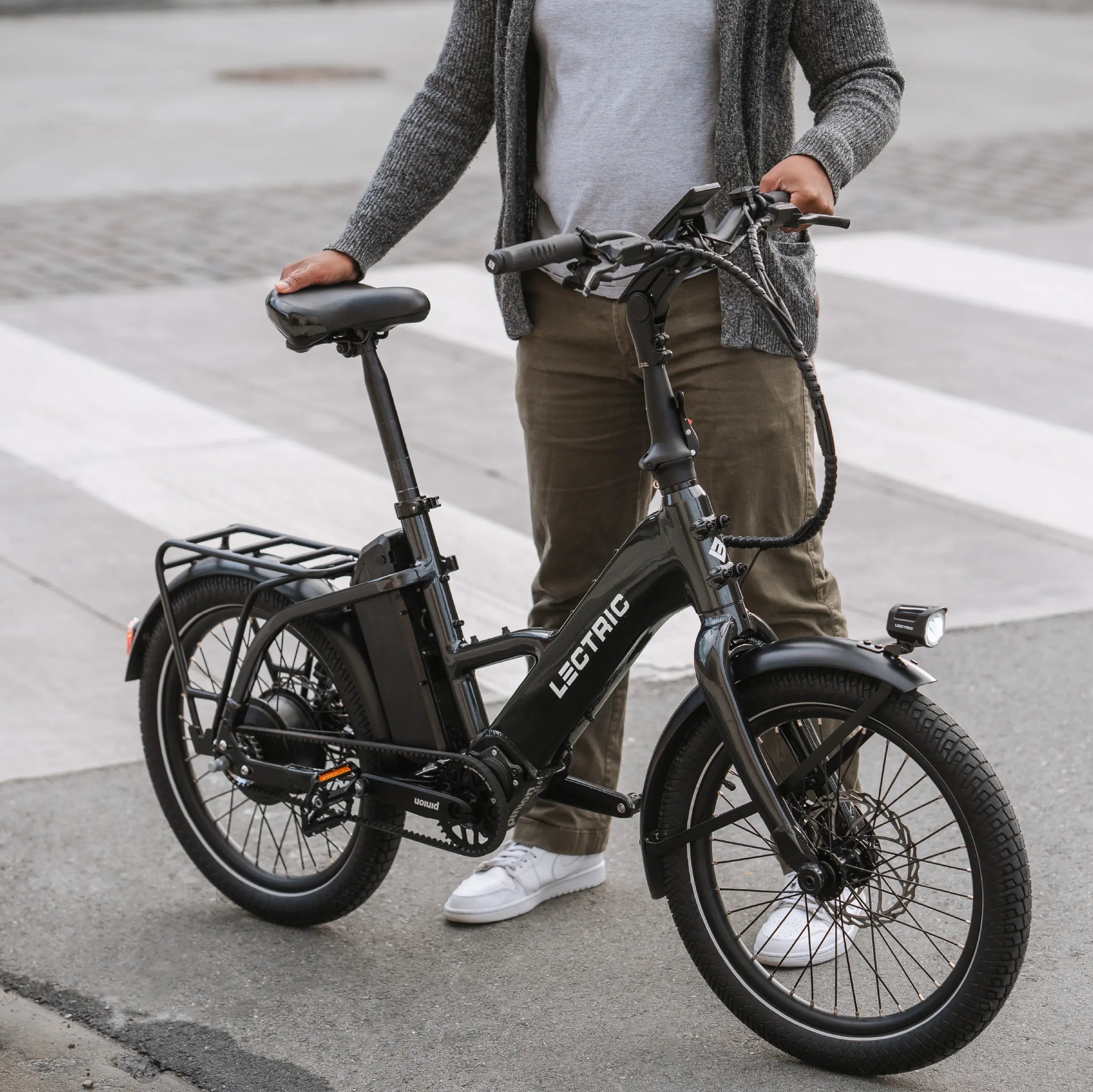 man holding Lectric ONE ebike on road