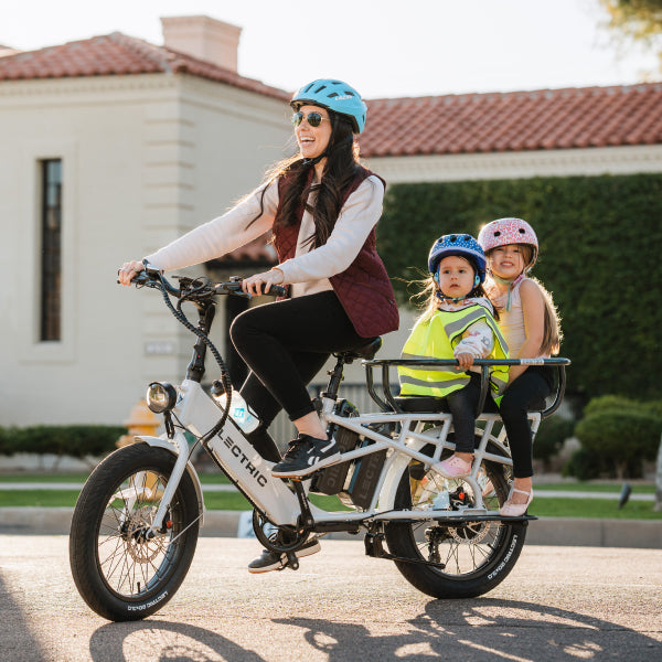 mom and kids riding lectric ebike in neighborhood