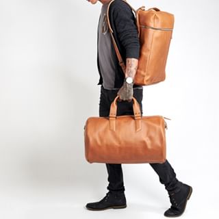 hombre con mochila y bolso de cuero