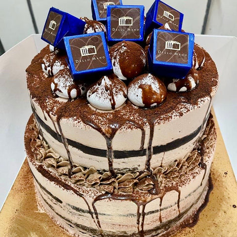 A double Chocolate Milkshake cake decorated with blue Dello Mano Luxury Brownies and meringues