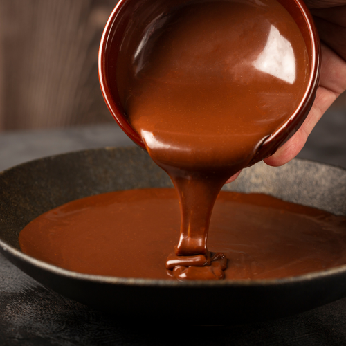 Chocolate Ganache pouring into a in a bowl