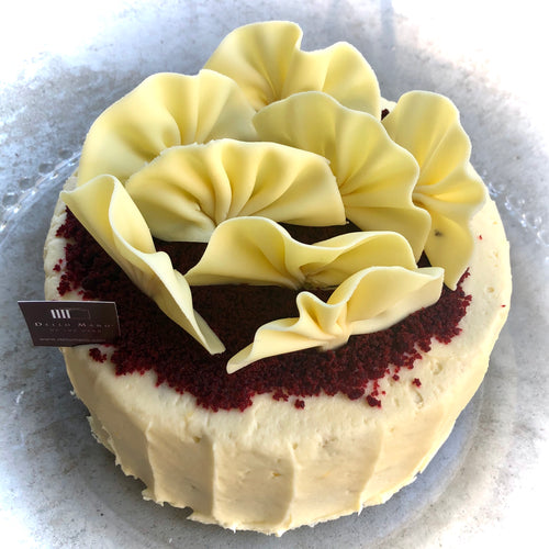Top view of a Dello Mano Red Velvet Cake with White Chocolate fans