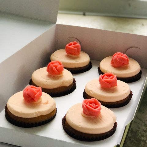 A box of Mothers Day rose cupcakes