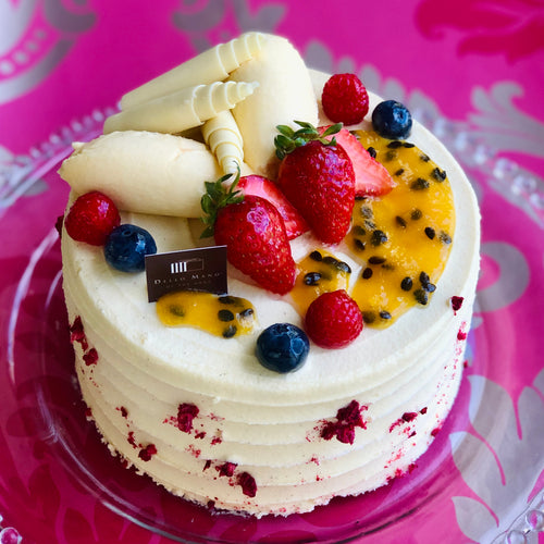 Dello Mano Raspberry Passionfruit Torte cake with pink background