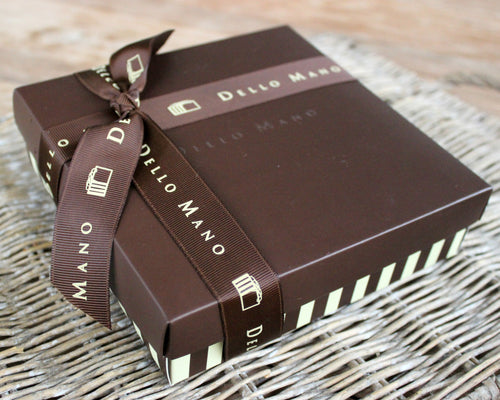 A Dello Mano Brownie Gift Box on cane plate