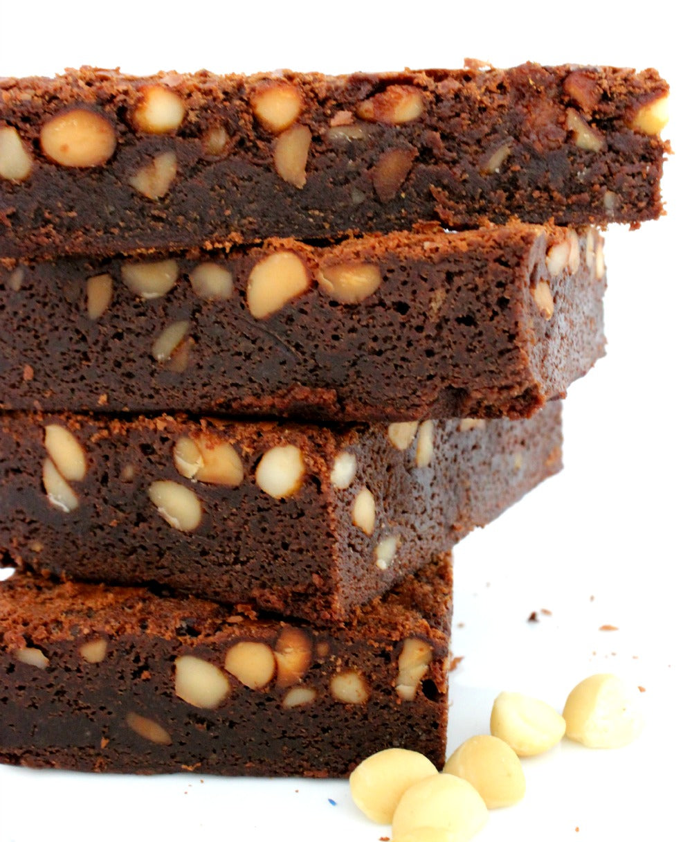 A stcck of slabs of honey macadamia brownies