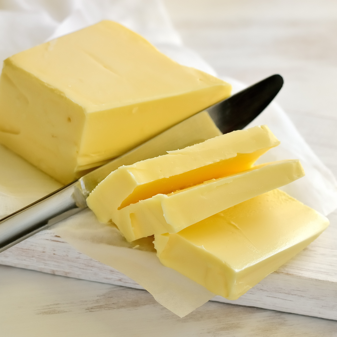 Butter sliced with knife on a bench