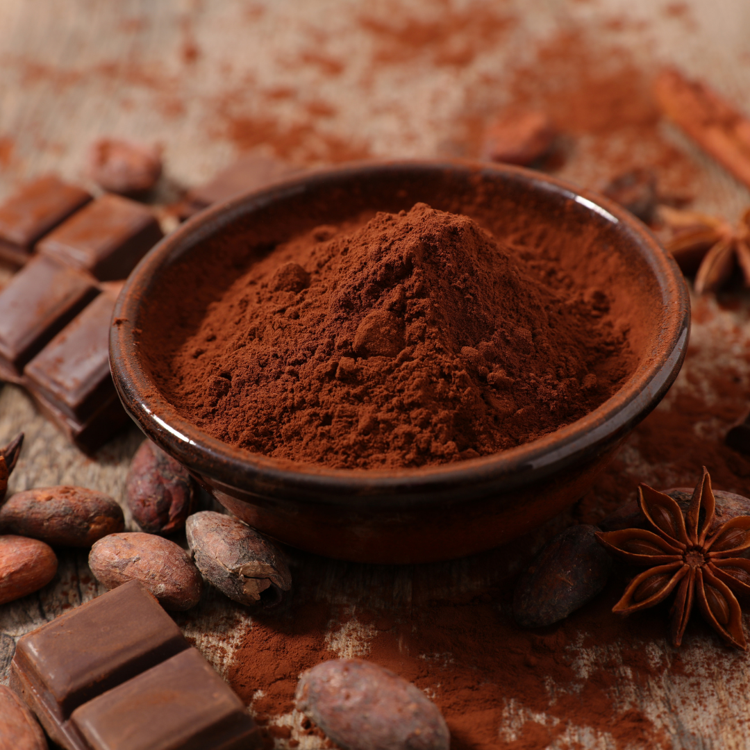 A bowl of rich cocoa powder with chocolate surrounding